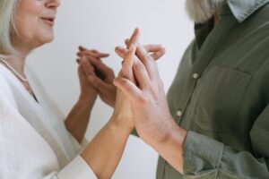 Close-up of an elderly couple lovingly holding hands, symbolizing enduring love and connection.