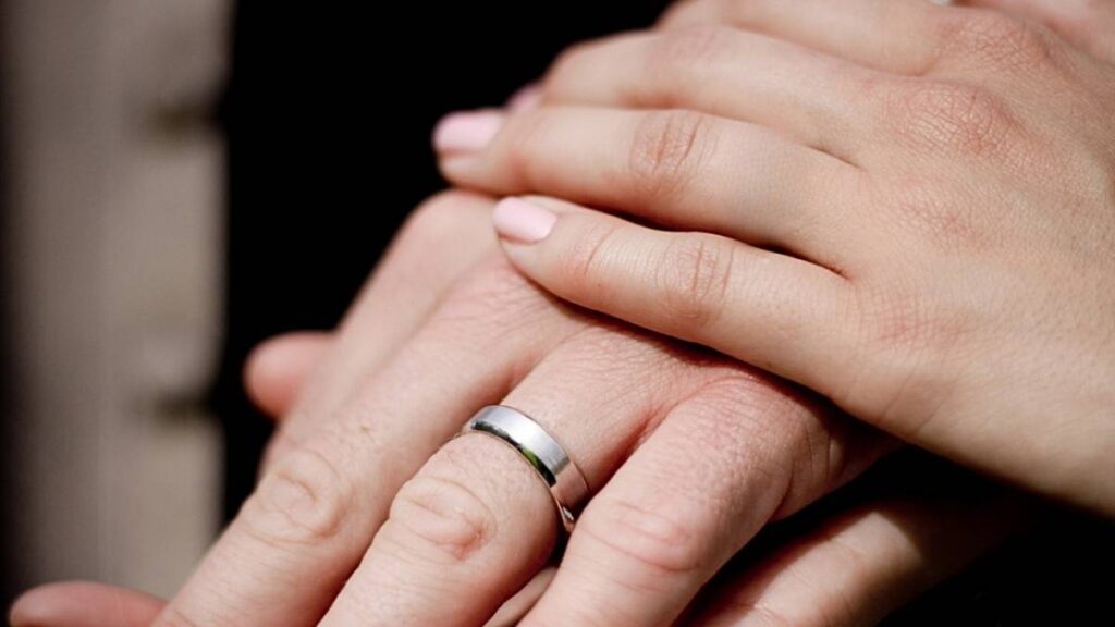 hand van een ongehuwde vrouw op een getrouwde man